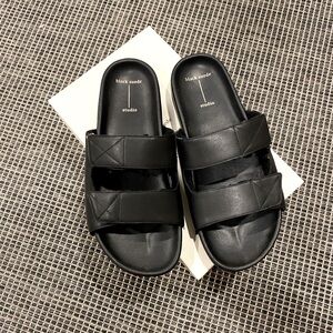Black leather and shearling lined slides by Black Suede Studios, size 40